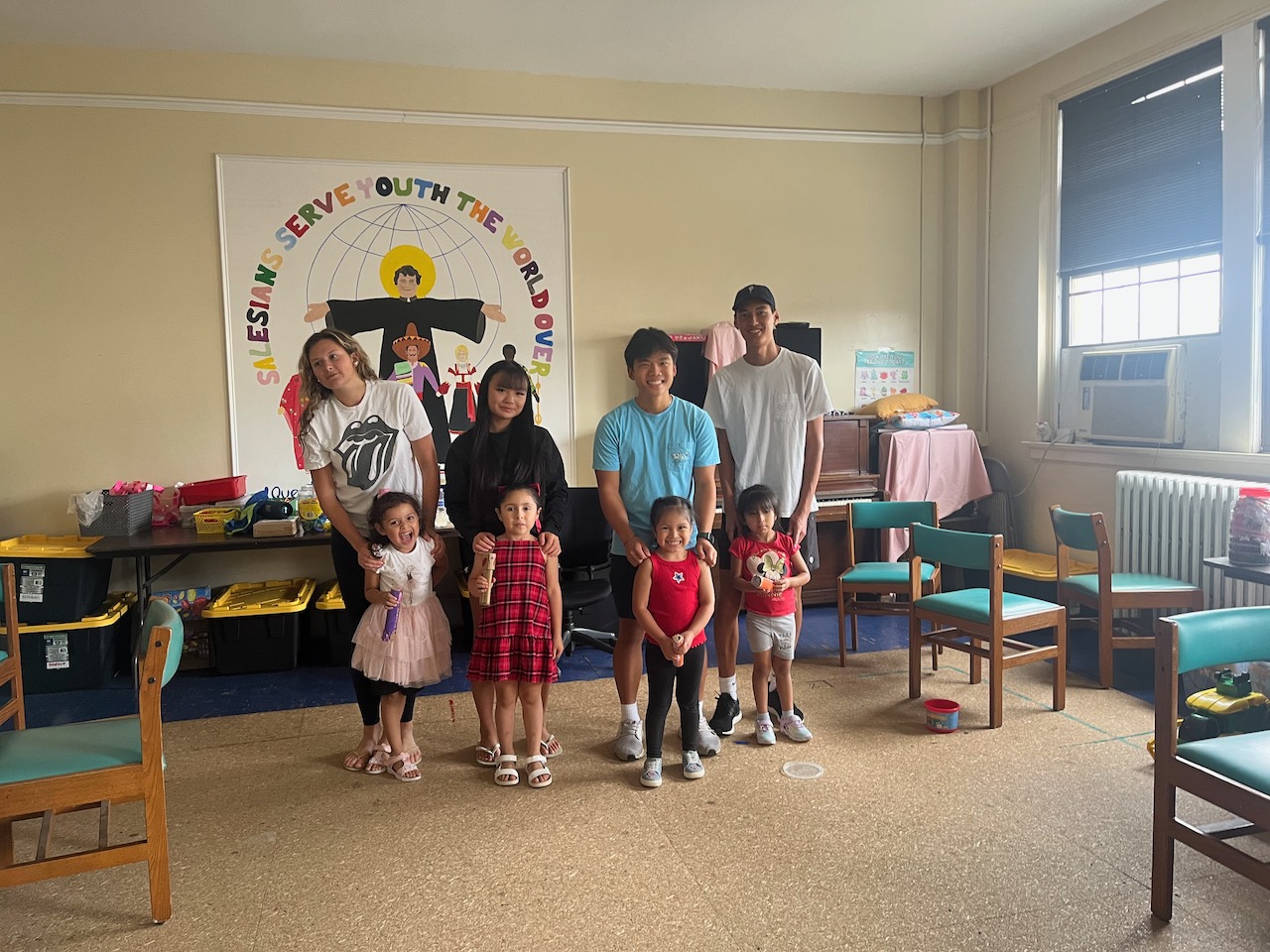 Art Club volunteers and young students gathered together at Don Bosco Community Center.