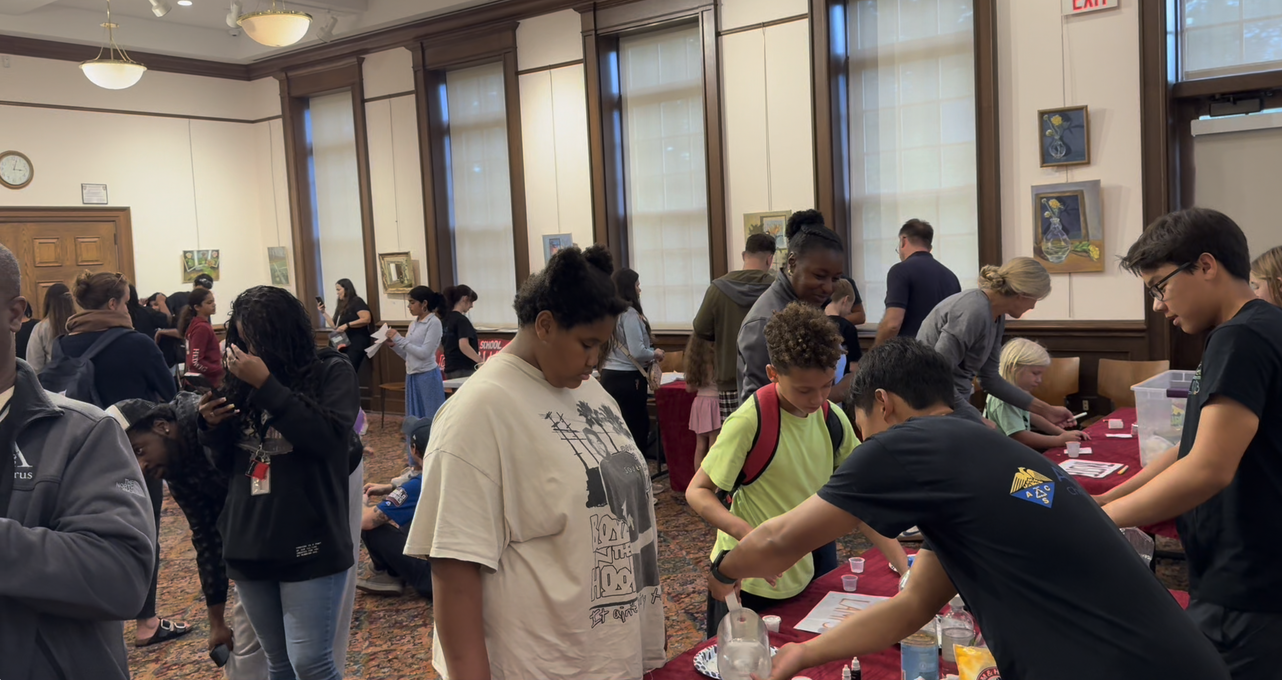 Chemistry Club volunteers sharing hands-on experiments with visitors at Rye Library.