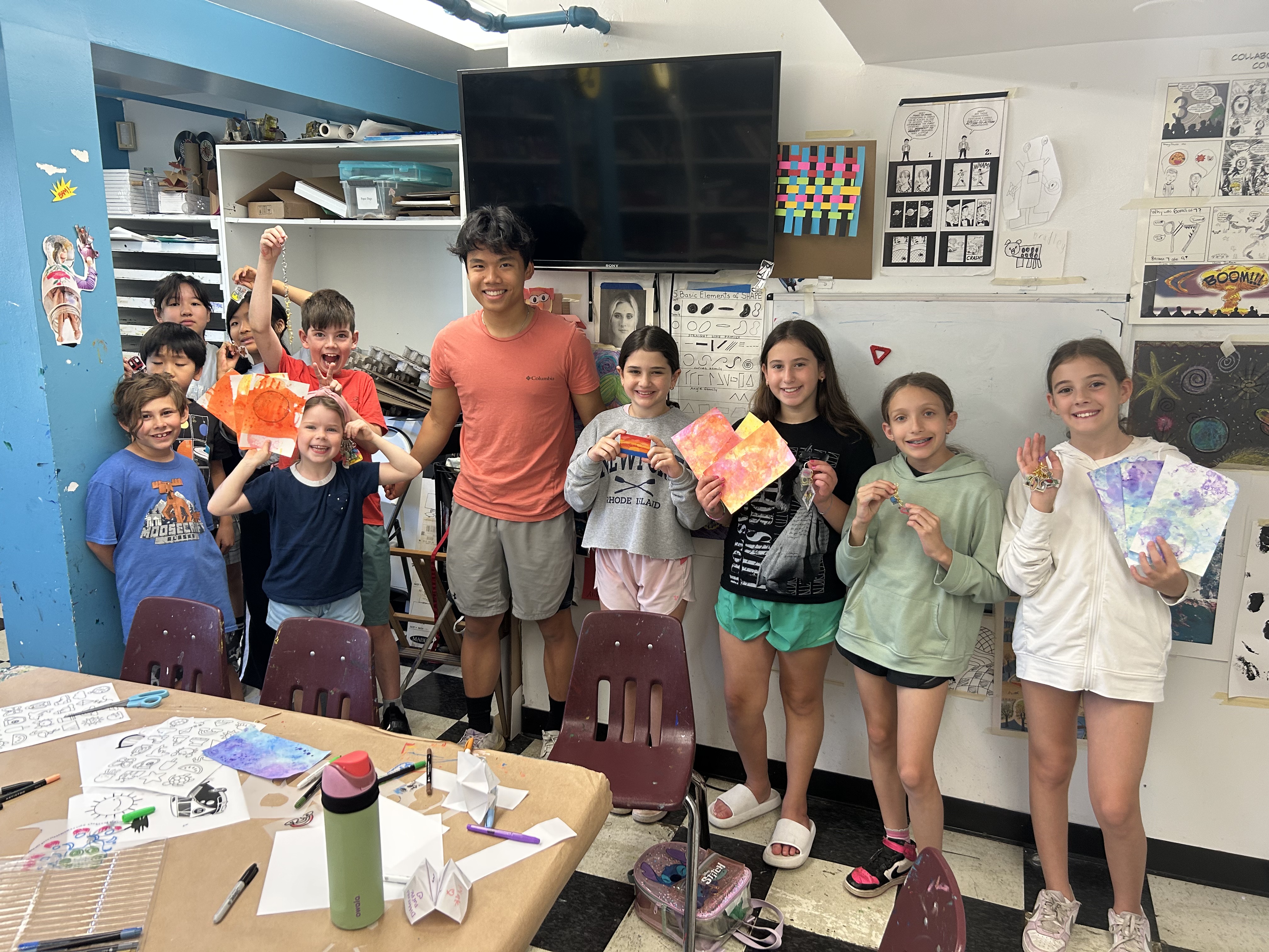 Thomas with students at Rye Arts Center displaying their artwork.