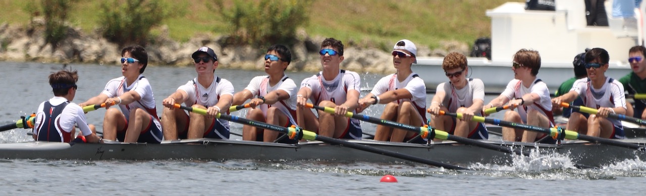 A panoramic side view of the RowAmerica Rye eight and their coxswain during a race.